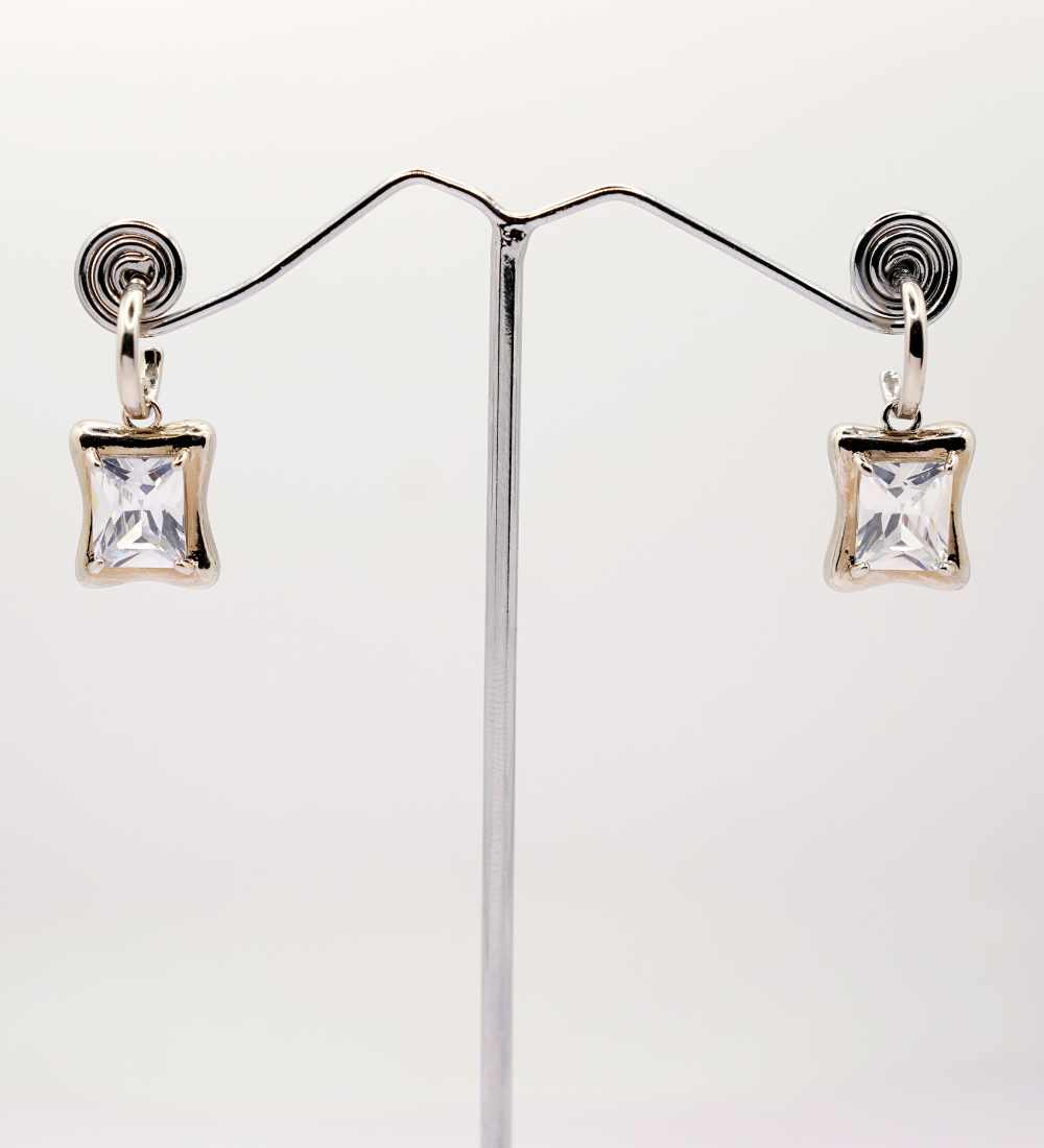Pair of silver dangle earrings with clear square-cut gemstones